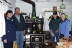 Lois and Franklin Marsh, Wayne and Val Furber with the old wood stove
